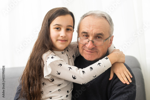 Elderly eighty plus year old man with granddaughter in a home setting.