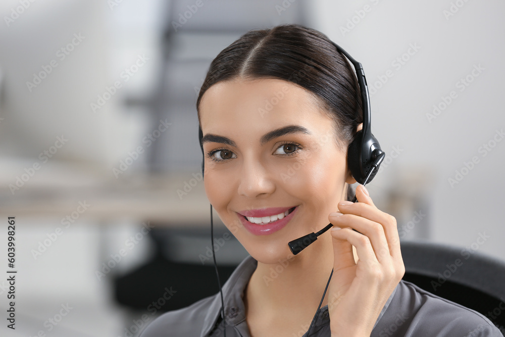 Hotline operator with headset working in office Hotline operator with headset working in office