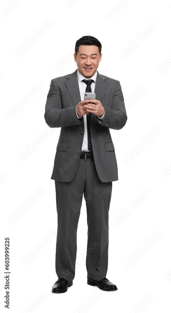 Businessman in suit using smartphone on white background