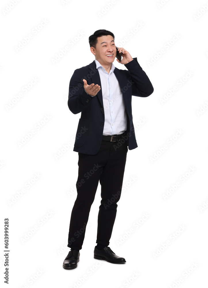 Businessman in suit talking on phone against white background Businessman in suit talking on phone against white background