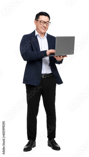 Businessman in suit with laptop on white background