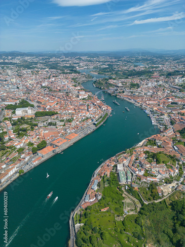 Aerial view of the Douro River in Porto. Aerial drone view of the city of Porto in Lisbon  the image includes bridges  riverside and the typical houses of the city  fado