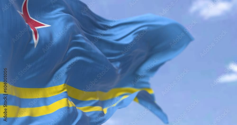 Seamless loop in slow motion of Aruba flag waving in the wind on a clear day
