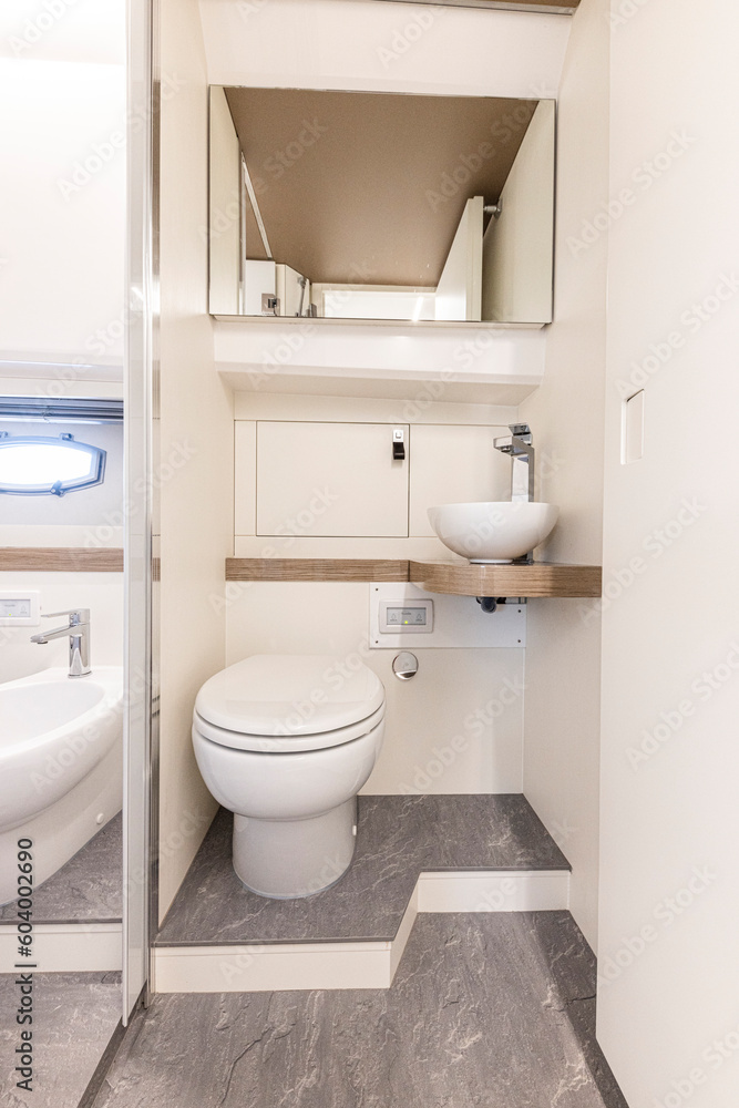 yacht Interior of a modern bathroom with white bathtub and toilet. Nobody inside yacht Interior of a modern bathroom with white bathtub and toilet. Nobody inside