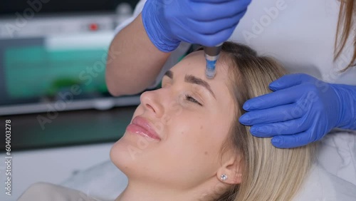 Hardware cosmetology mesotherapy, dermapen, treatment of the face area, facial rejuvenation. photo