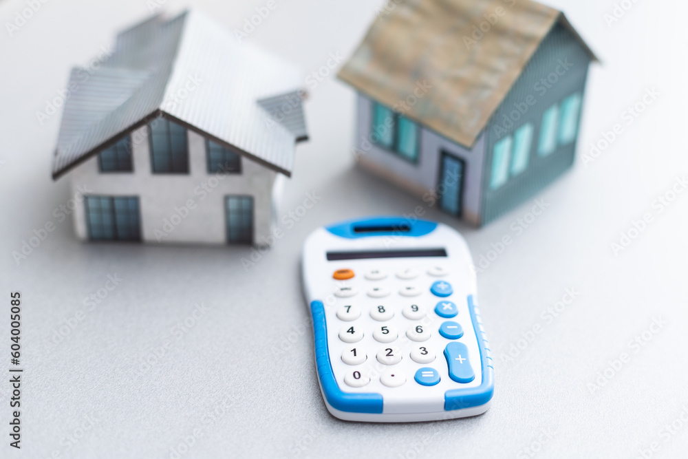 House is placed on the calculator. Imagine calculating to buy a home. planning savings money to buy a home concept for property, mortgage and real estate investment. to buy a house. House is placed on the calculator. Imagine calculating to buy a home. planning savings money to buy a home concept for property, mortgage and real estate investment. to buy a house.