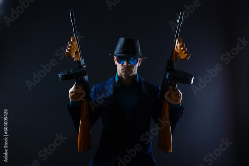 Mature man in sunglasses with gun photo