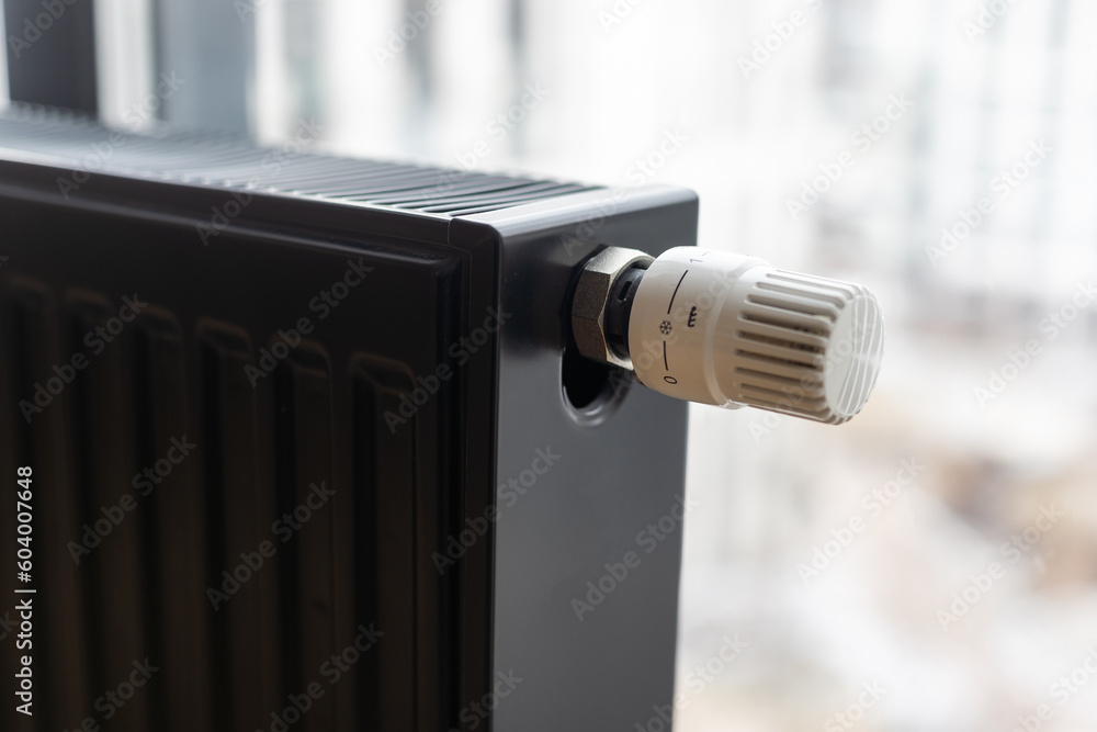 Heating radiator in room with laminated wooden floor Heating radiator in room with laminated wooden floor