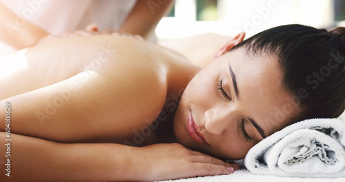 Woman, relax and sleeping in back massage at spa for healthy wellness, skincare or stress relief at a resort. Calm female person relaxing asleep in peaceful zen or luxury body treatment at the salon