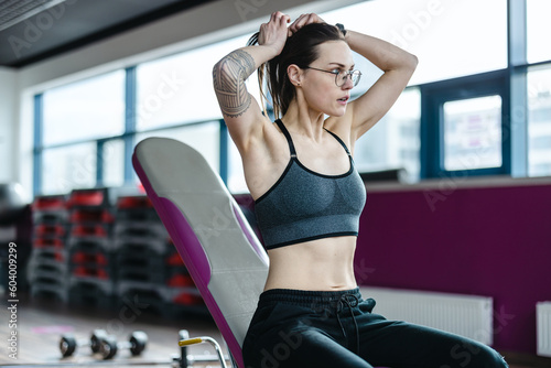 Portrait of a athletic young woman exercising in a gym