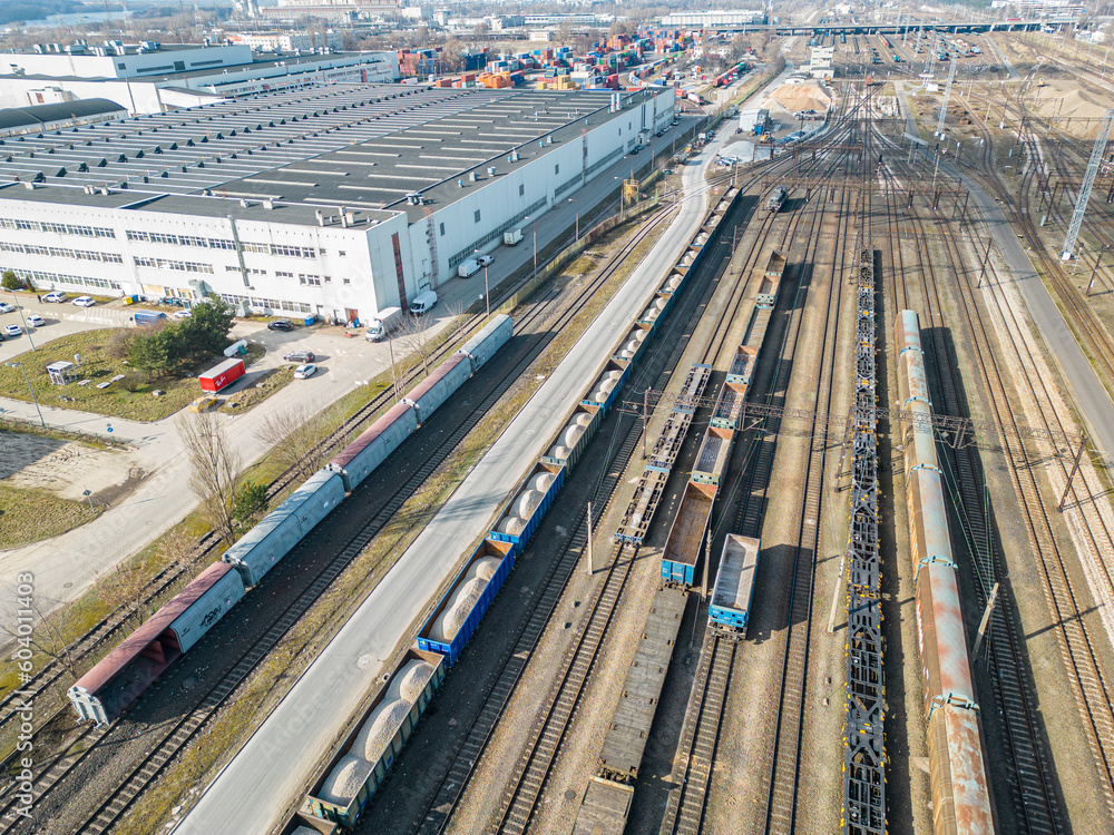 Cargo trains close-up. Aerial view of colorful freight trains on the railway station. Wagons with goods on railroad. Heavy industry. Industrial conceptual scene with trains. Top view from flying drone Cargo trains close-up. Aerial view of colorful freight trains on the railway station. Wagons with goods on railroad. Heavy industry. Industrial conceptual scene with trains. Top view from flying drone