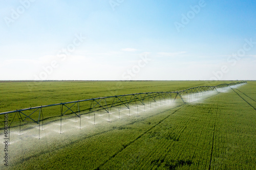Center pivot crop irrigation or irrigation system for farm management. Watering system in the field. An irrigation pivot watering a field