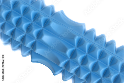 A blue massage foam roller and isolated on a white background. Close-up. Foam rolling is a self myofascial release technique. Concept of fitness equipment.