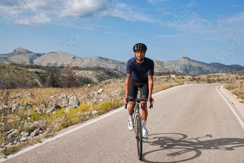 Pass Vall De Ebo. Cyclist training on road bike in mountain. Sport motivation. Cycling holiday in Spain.