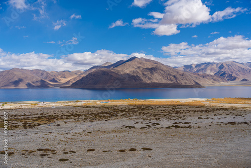 Mountains and Pangong tso (Lake). It is huge lake in Ladakh, altitude 4,350 m (14,270 ft). It is 134 km (83 mi) long and extends from India to Tibet. Leh, Ladakh, Jammu and Kashmir, India