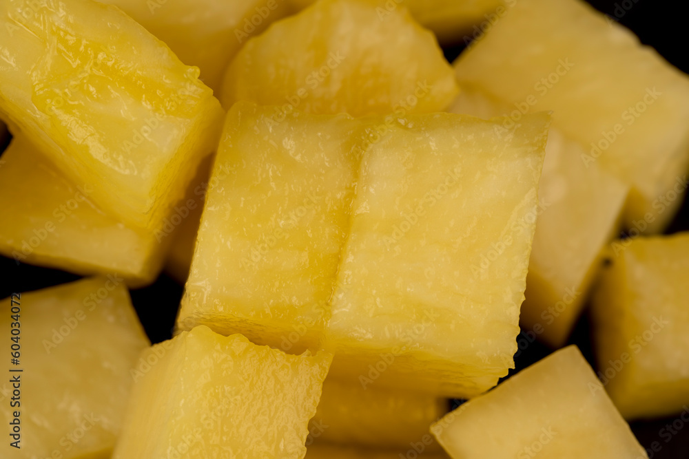sliced ripe yellow pineapple, a large number of pieces sliced ripe yellow pineapple, a large number of pieces