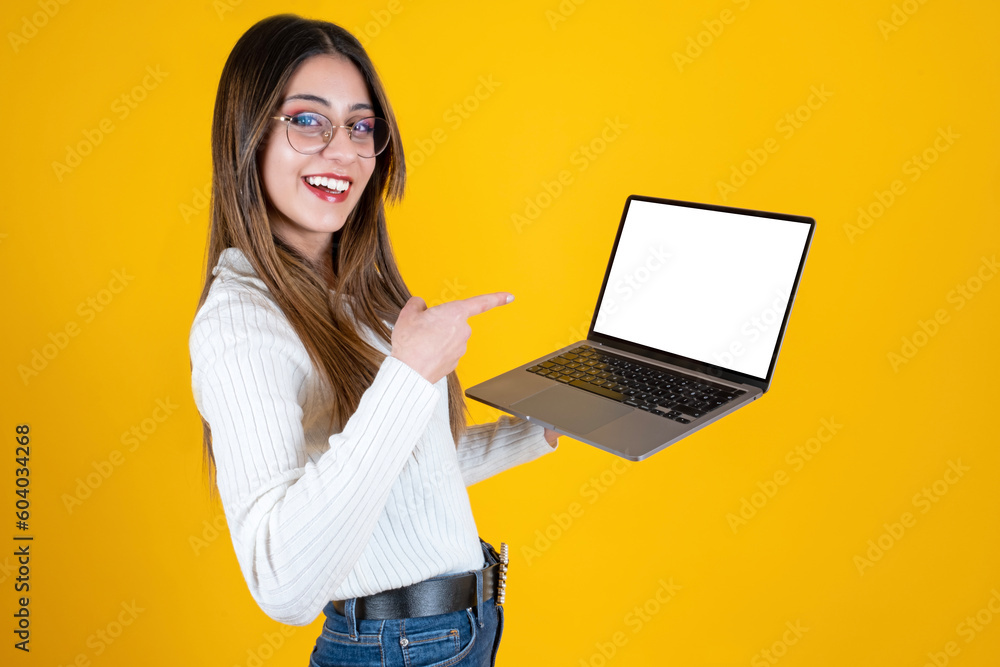 Pointing laptop screen, side view portrait of woman pointing laptop screen. Young businesswoman holding notebook, empty blank screen for mockup. Showing display with her finger. Smiling, happy girl. Pointing laptop screen, side view portrait of woman pointing laptop screen. Young businesswoman holding notebook, empty blank screen for mockup. Showing display with her finger. Smiling, happy girl.