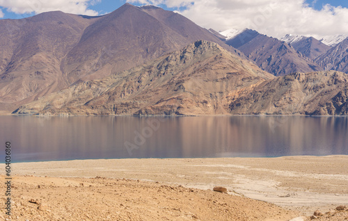 beautiful scenery of Pangong lake, blue lake water, blue sky, snow mountain surrounded at Pagong Tso, Leh, Ladakh, Jammu and Kashmir, India photo