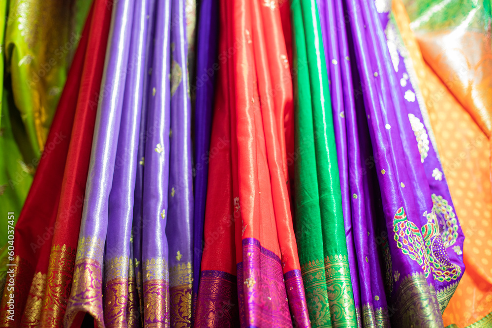 Bright silk oriental shawls and shawls with various patterns hang in window of trade pavilion at oriental market. Bright silk oriental shawls and shawls with various patterns hang in window of trade pavilion at oriental market.