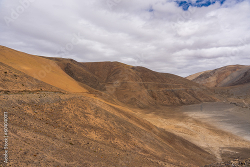 Landscape of Desert mountains against clouds sky at the way from Pangong Lake to Tso Moriri, Leh, Ladakh, Jammu and Kashmir, India