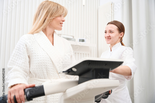 Lady in a medical center undergoes a bioimpedancemetry diagnostic procedure