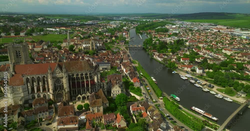 Establishing shot of the French center of the medieval city of Auxerre which is separated by the Yonne river. Red roofs of historic, ancient houses in France. Burgundy is oldest regions of France Establishing shot of the French center of the medieval city of Auxerre which is separated by the Yonne river. Red roofs of historic, ancient houses in France. Burgundy is oldest regions of France