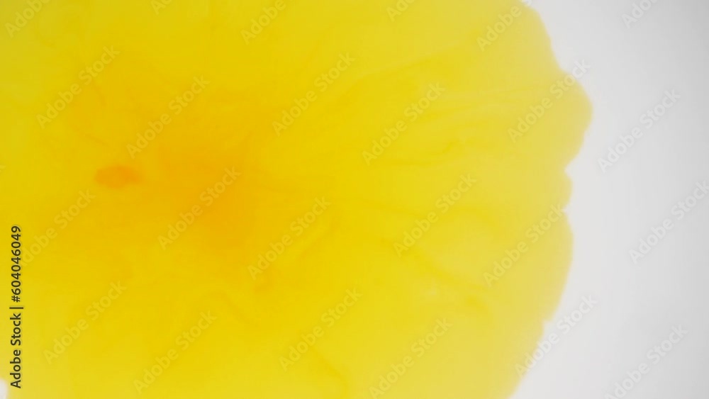 yellow color ink dropped on a white background liquid yellow color ink dropped on a white background liquid