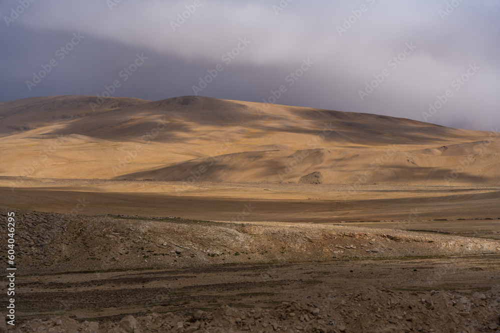 Landscape of Desert mountains against clouds sky at the way from Pangong Lake to Tso Moriri, Leh, Ladakh, Jammu and Kashmir, India Landscape of Desert mountains against clouds sky at the way from Pangong Lake to Tso Moriri, Leh, Ladakh, Jammu and Kashmir, India