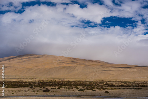 Landscape of Desert mountains against clouds sky at the way from Pangong Lake to Tso Moriri, Leh, Ladakh, Jammu and Kashmir, India
