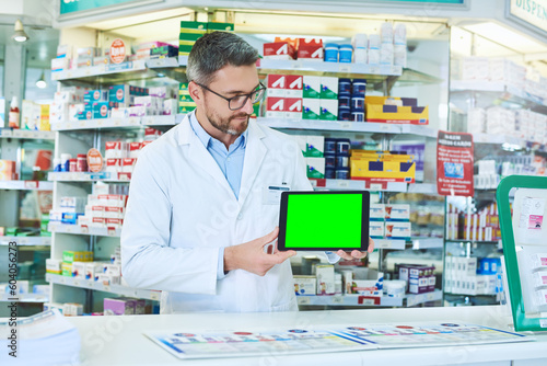 Man, pharmacist and tablet with green screen with healthcare, store and mockup with pharmaceutical promo on app. Mature pharma expert, digital touchscreen and space with chromakey for mock up in shop