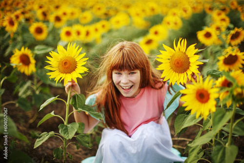 Happy little girl on the field of sunflowers in summer. beautiful little girl in sunflowers