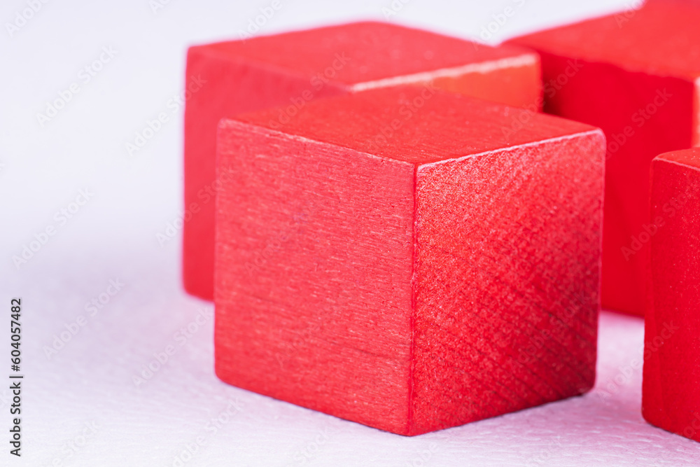 Red wooden cubes on a white background, top view. Abstract background with cubes. Red wooden cubes on a white background, top view. Abstract background with cubes.