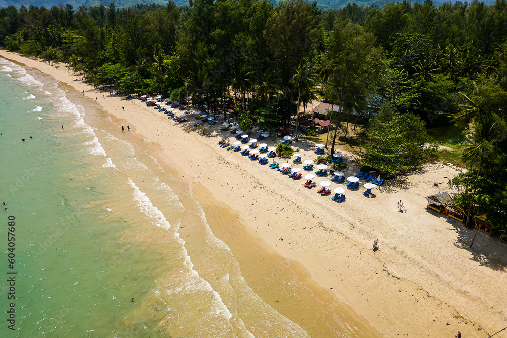 Aerial view of a small beach bar on a tropical sandy beachd fringed by palm trees (Thailand)