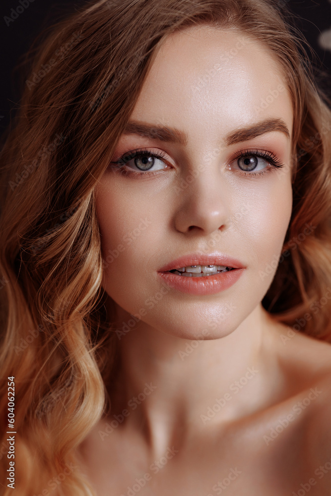 Obraz premium Beautiful woman with healthy glowing hydrated skin. Studio portrait of a woman satisfied with an anti-aging skin care procedure. Beautiful teeth with braces.