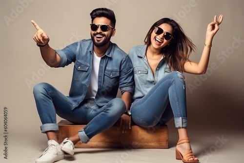 Indian couple sitting on the floor wearing jeans and sunglasses generative ai