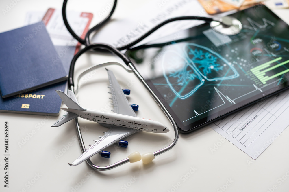 Modern social health insurance program. Tablet computer with healthcare application interface on screen. Stethoscope, x-ray image and cardiogram on wooden desk. Digital healthcare technologies. Modern social health insurance program. Tablet computer with healthcare application interface on screen. Stethoscope, x-ray image and cardiogram on wooden desk. Digital healthcare technologies.