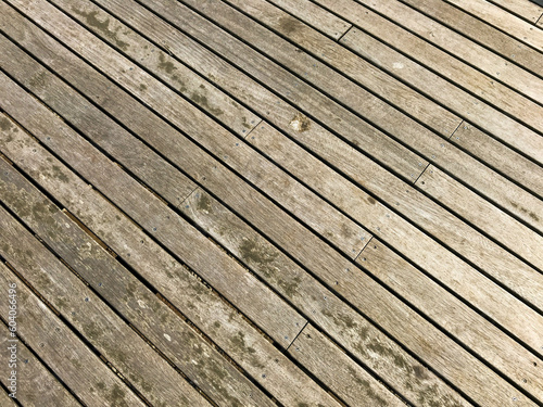 Pattern formed by wooden planks on outdoor decking in a garden. No people.