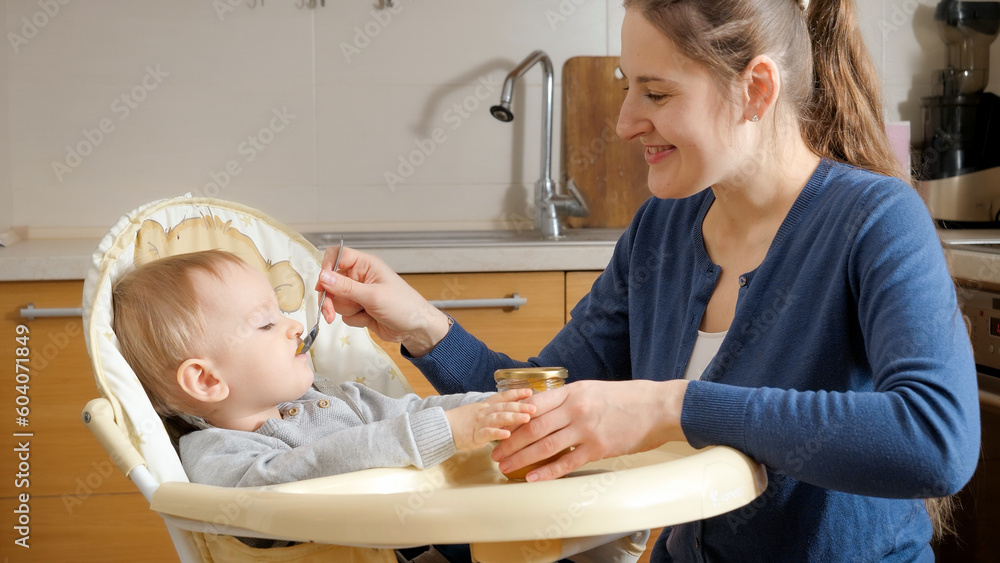 Portrait of cute baby opens mouth while spoon like airplane flies in his mouth. Concept of parenting, healthy nutrition and baby care. Portrait of cute baby opens mouth while spoon like airplane flies in his mouth. Concept of parenting, healthy nutrition and baby care.