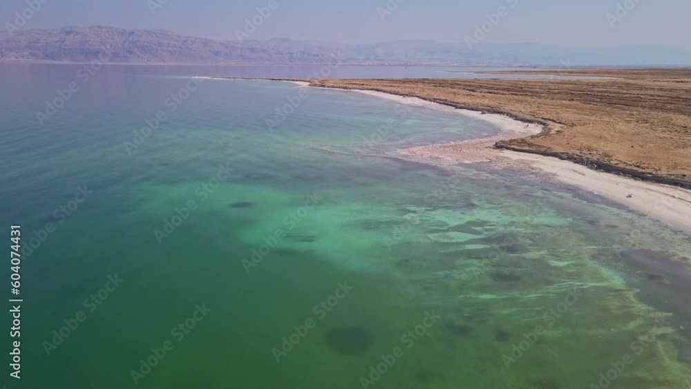 Landscape, nature and mountains with coastline of dead sea for environment, desert and horizon. Lake, water and ecology with drone view of ocean in Israel for sunshine, adventure and climate Landscape, nature and mountains with coastline of dead sea for environment, desert and horizon. Lake, water and ecology with drone view of ocean in Israel for sunshine, adventure and climate