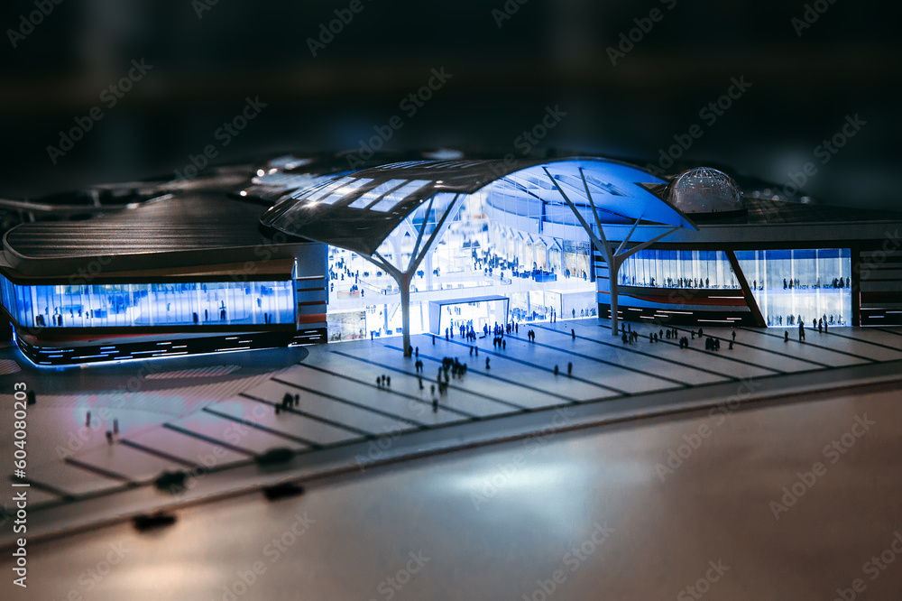 Model of modern shopping complex - hypermarket and silhouettes of people in front of the entrance - obrazy, fototapety, plakaty 