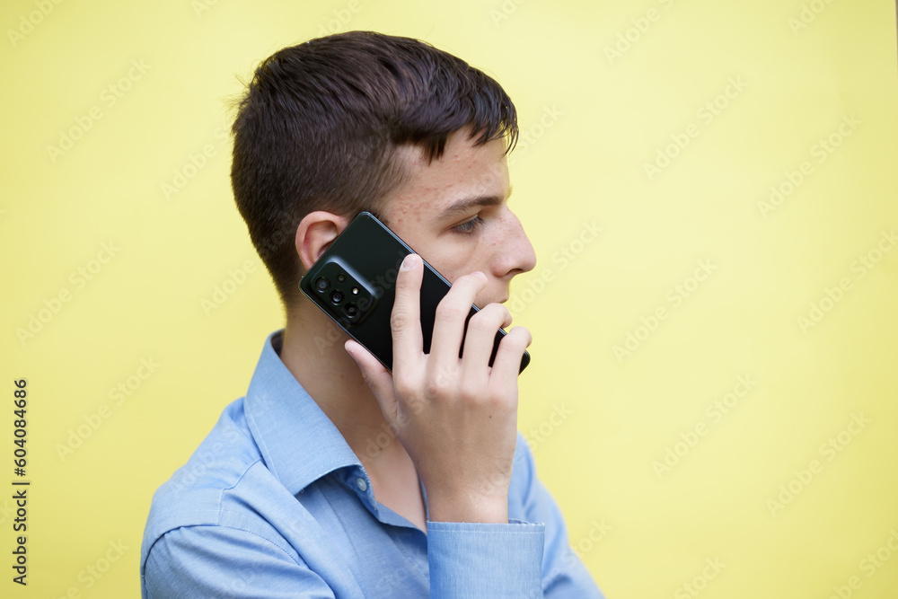 boy is talking on a mobile phone boy is talking on a mobile phone