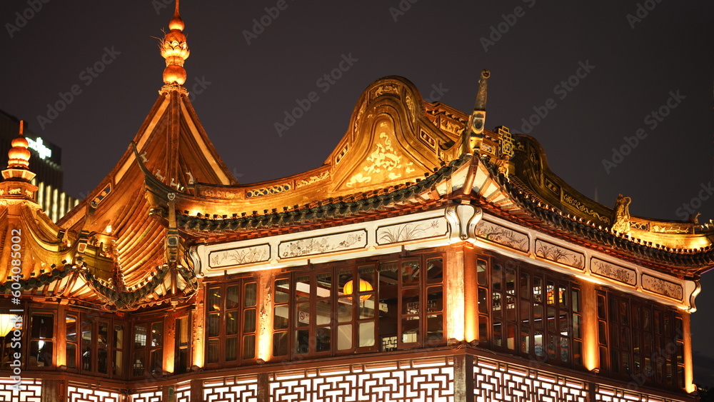 Obraz premium The old buildings night view with the lights on located in Shanghai of the city in China