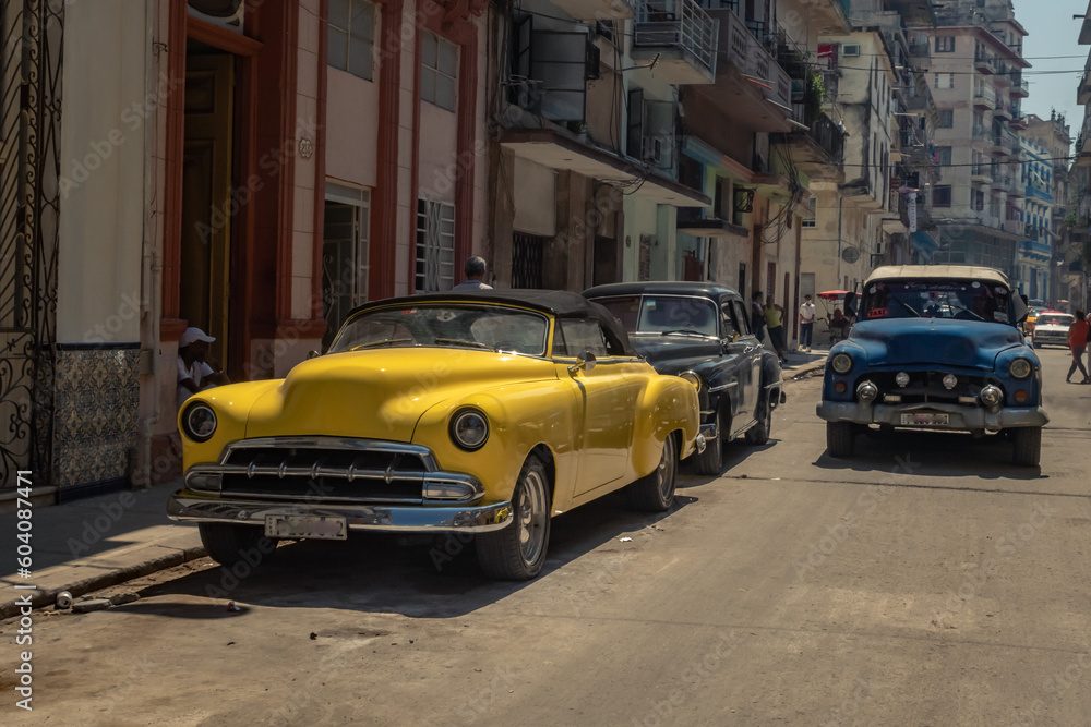 Old American car in the historic streets of Havana in Cuba with old buildings Old American car in the historic streets of Havana in Cuba with old buildings