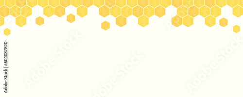 Beehive honey sign with hexagon grid cells on yellow background.