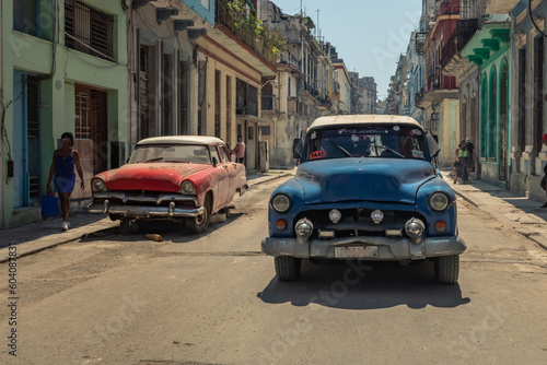 Old American car in the historic streets of Havana in Cuba with old buildings