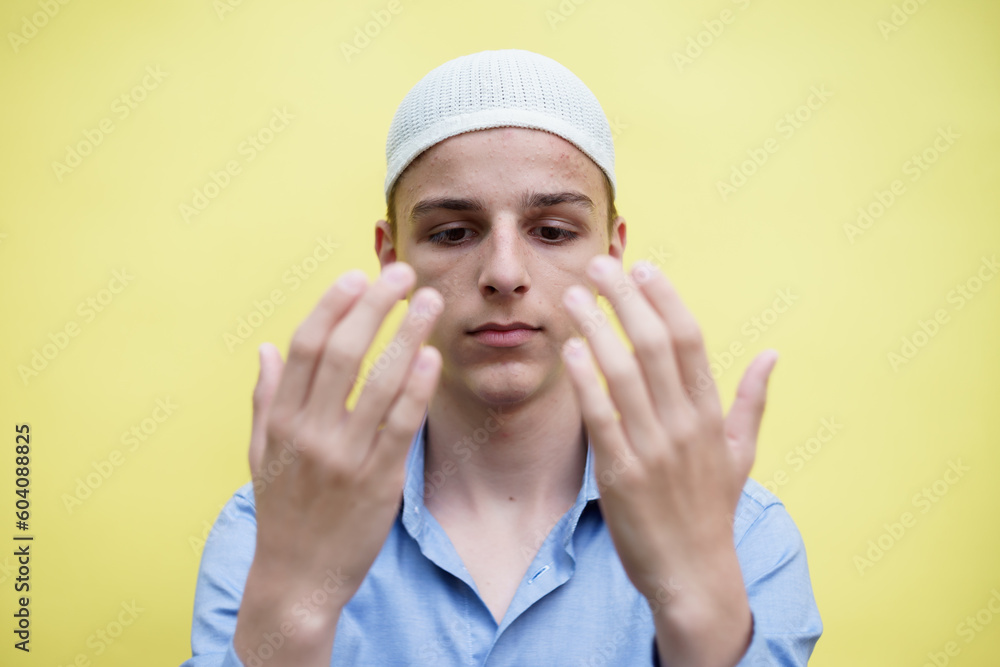 young muslim man praying, concept of peace, harmony and happy life filled with belief in God young muslim man praying, concept of peace, harmony and happy life filled with belief in God