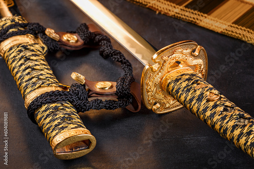 Japanese samurai katana sword and scabbard close up. Photo of a weapon in low key with selective focus photo