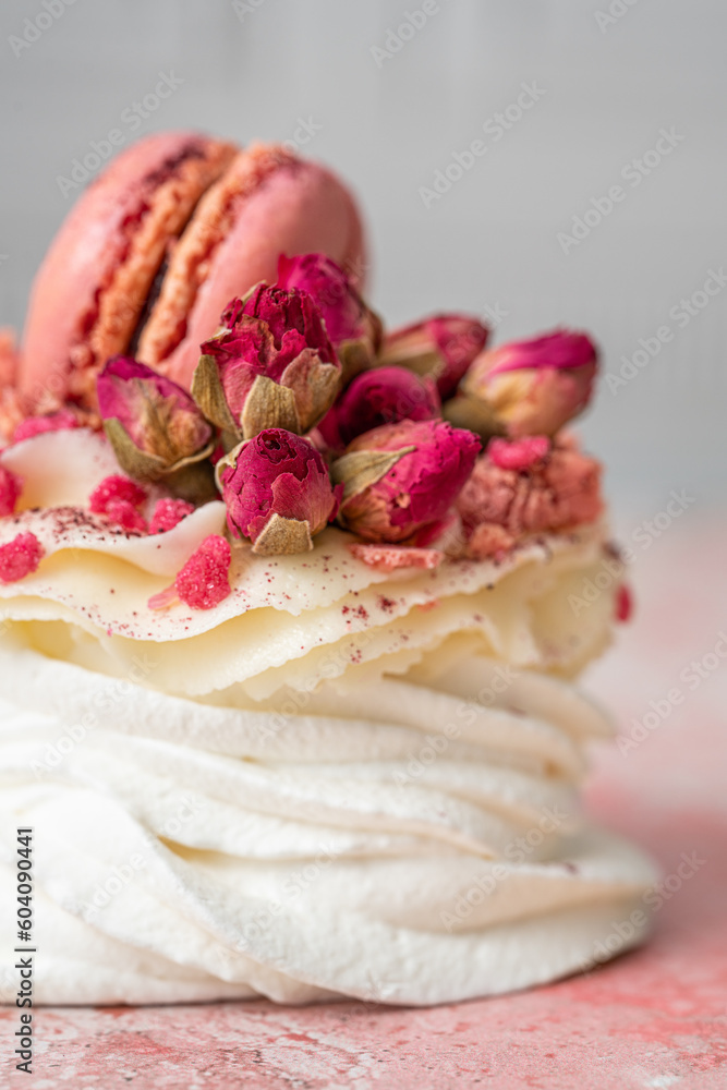 Mini pavlova with Philadelphia cheese frosting decorated with strawberry macaron and roses Mini pavlova with Philadelphia cheese frosting decorated with strawberry macaron and roses