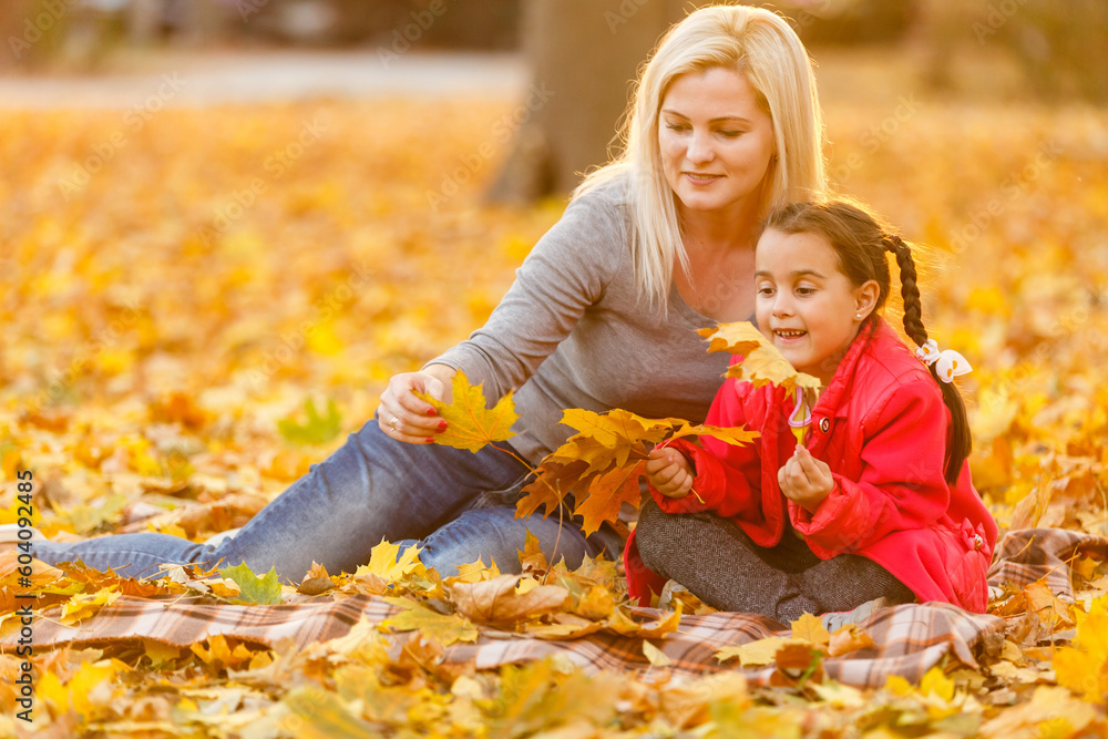 happy family mother and child daughter playing and laughing on autumn walk. happy family mother and child daughter playing and laughing on autumn walk.
