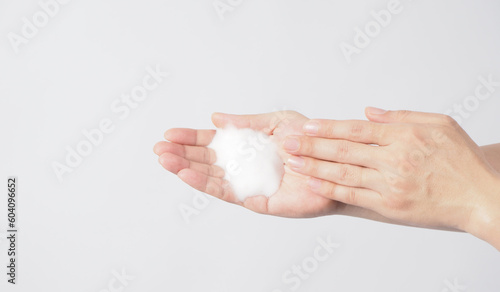 Hands washing gesture and foam hand soap on white background.